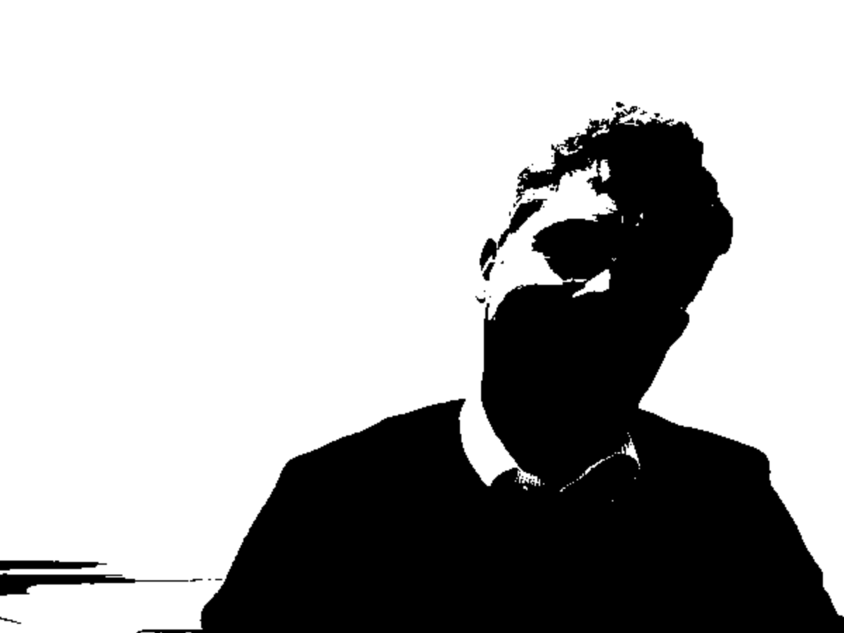 The same webcam portrait reduced to pure black and pure white shapes, the figure a solid silhouette against a white background.